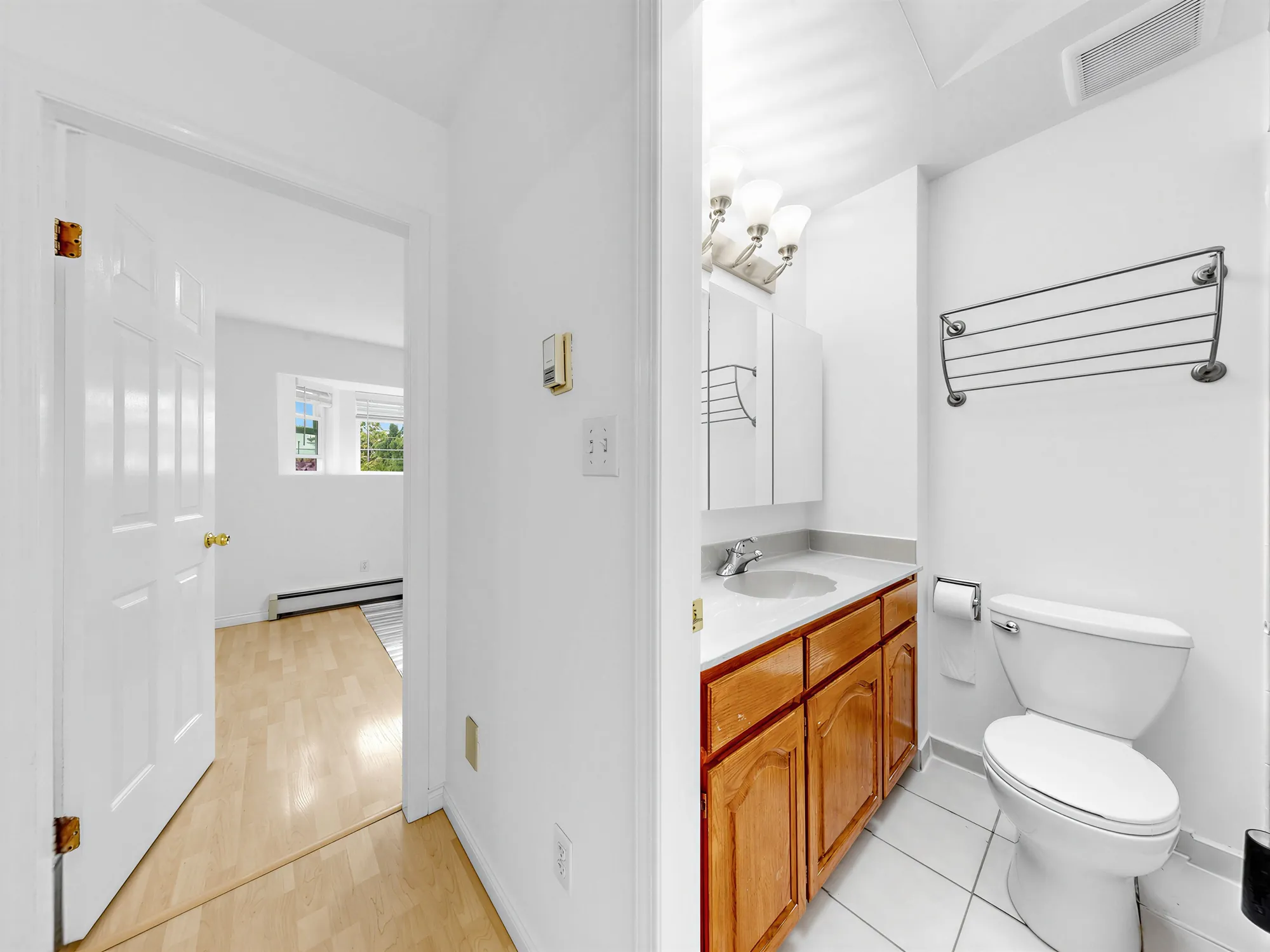 The same bathroom seen from the doorway, with the room beyond