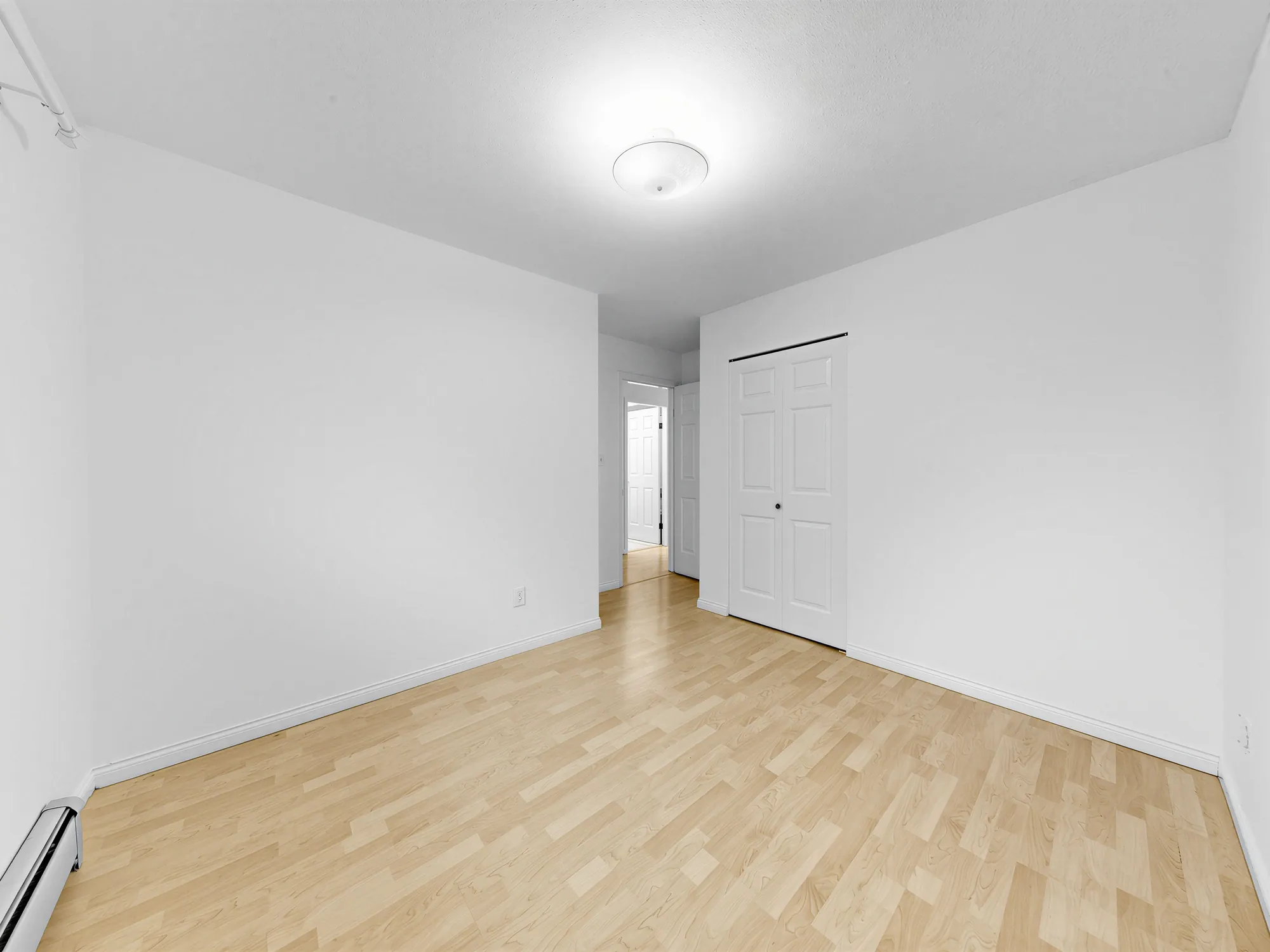 A room with a doorway and a closet