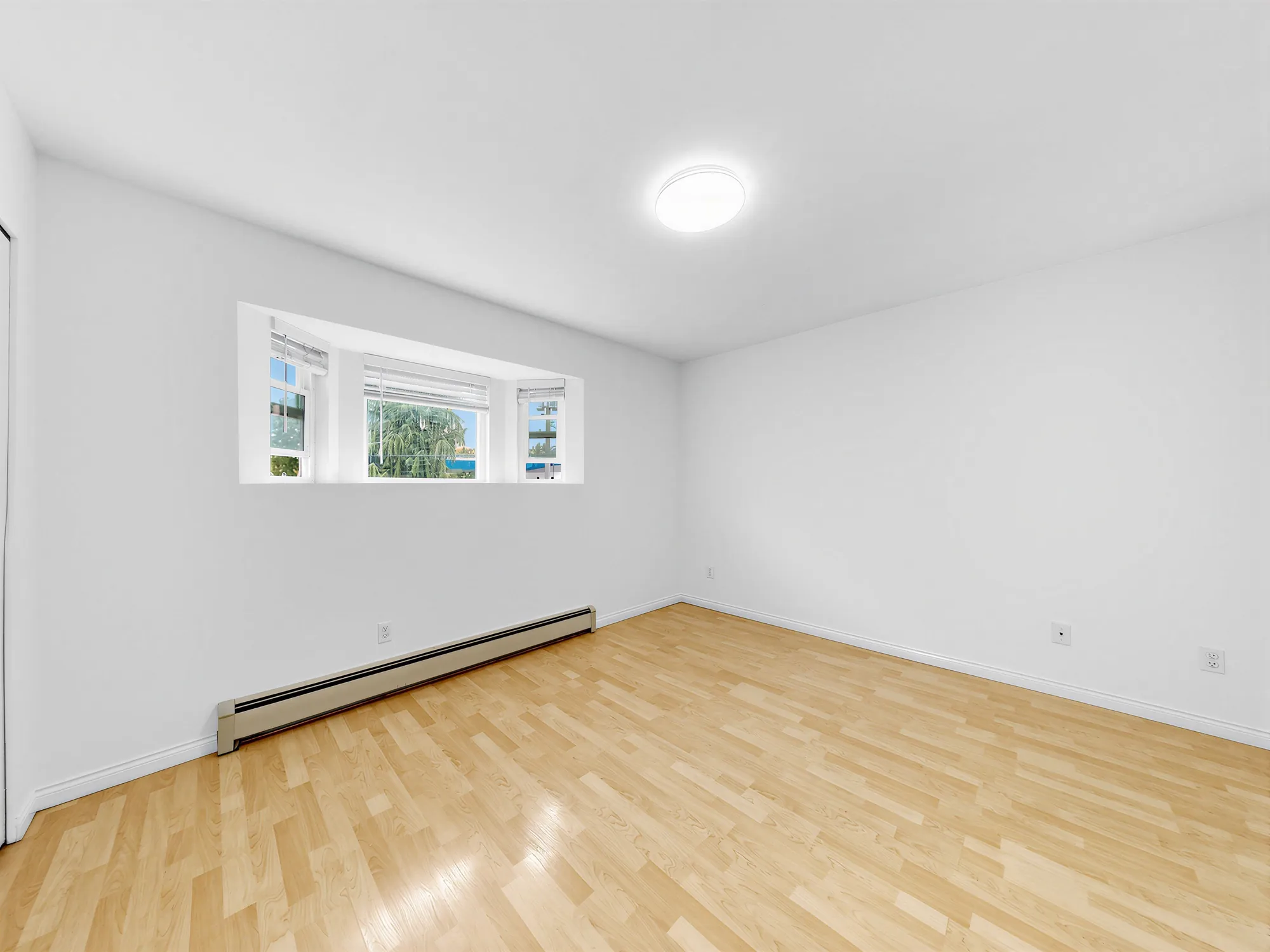 A room with a wide window set high in the wall