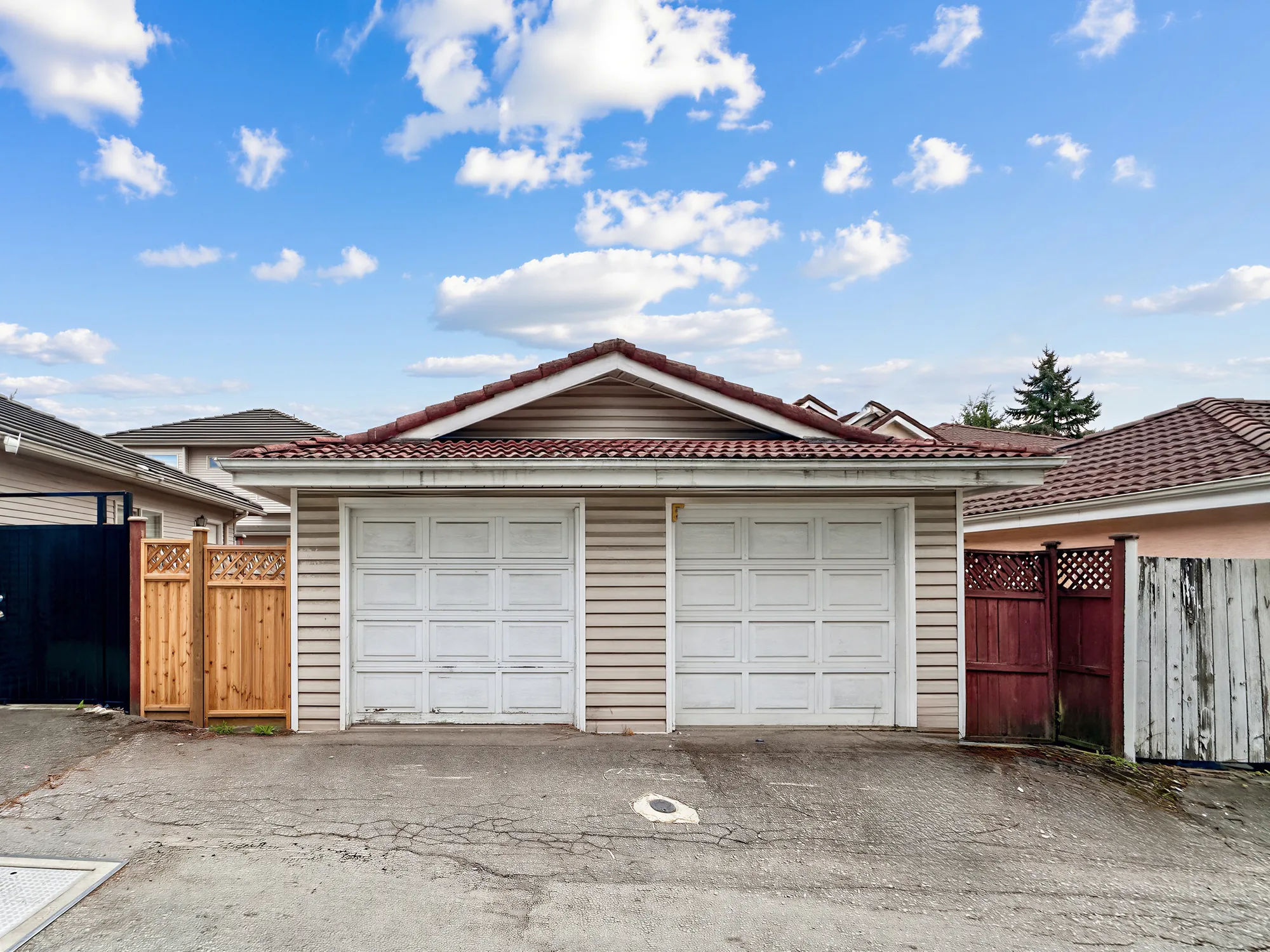Two garage doors seen from the lane