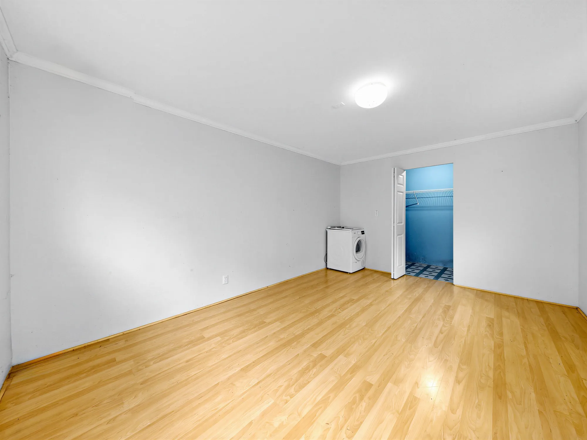 Inside the guest house from the other corner, showing the closet doorway and the washer