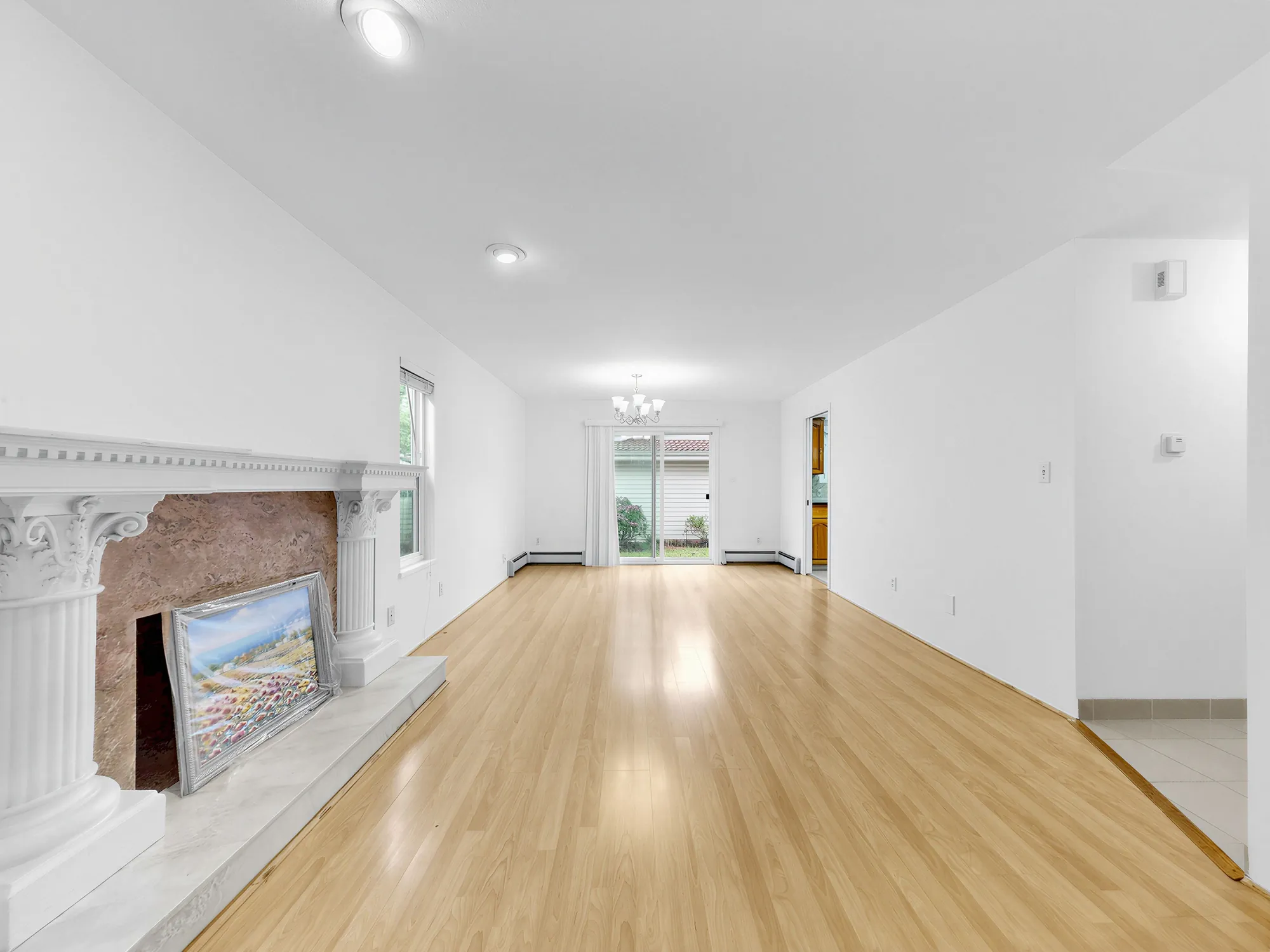 The living room looking along its length past the mantel