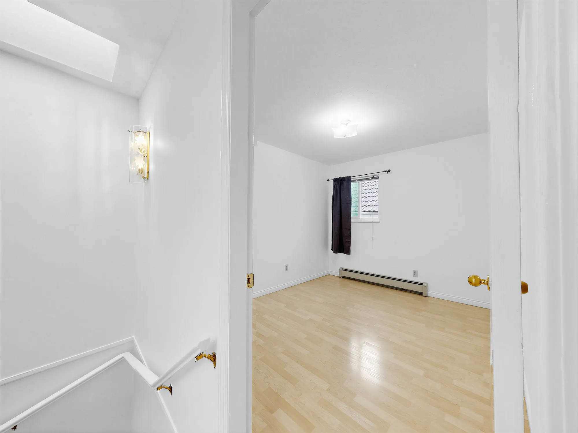 The upstairs landing with the stair rail and a room beyond